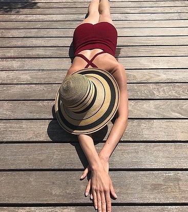 Olga Kurylenko sunbathing