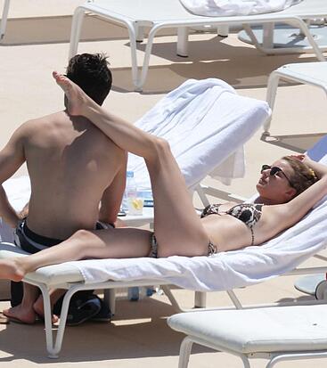 Emily VanCamp sunbathing in bikini